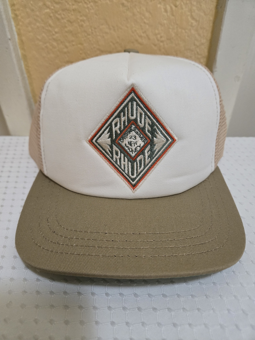 Rhude White Beige Trucker Hat with Orange Accent